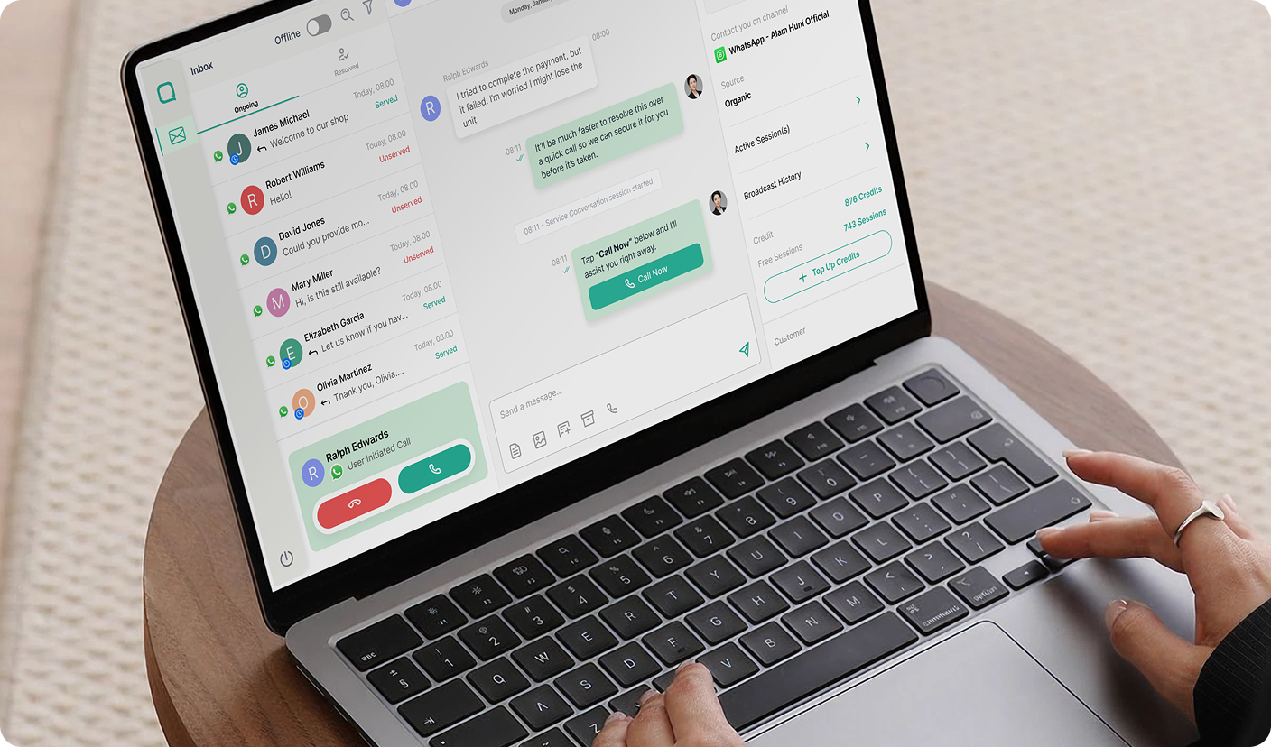 Qiscus omnichannel inbox on a laptop — book a demo