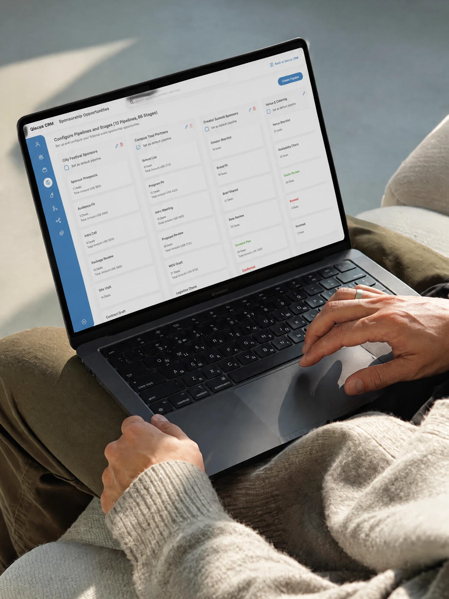 QCRM pipeline dashboard open on a laptop